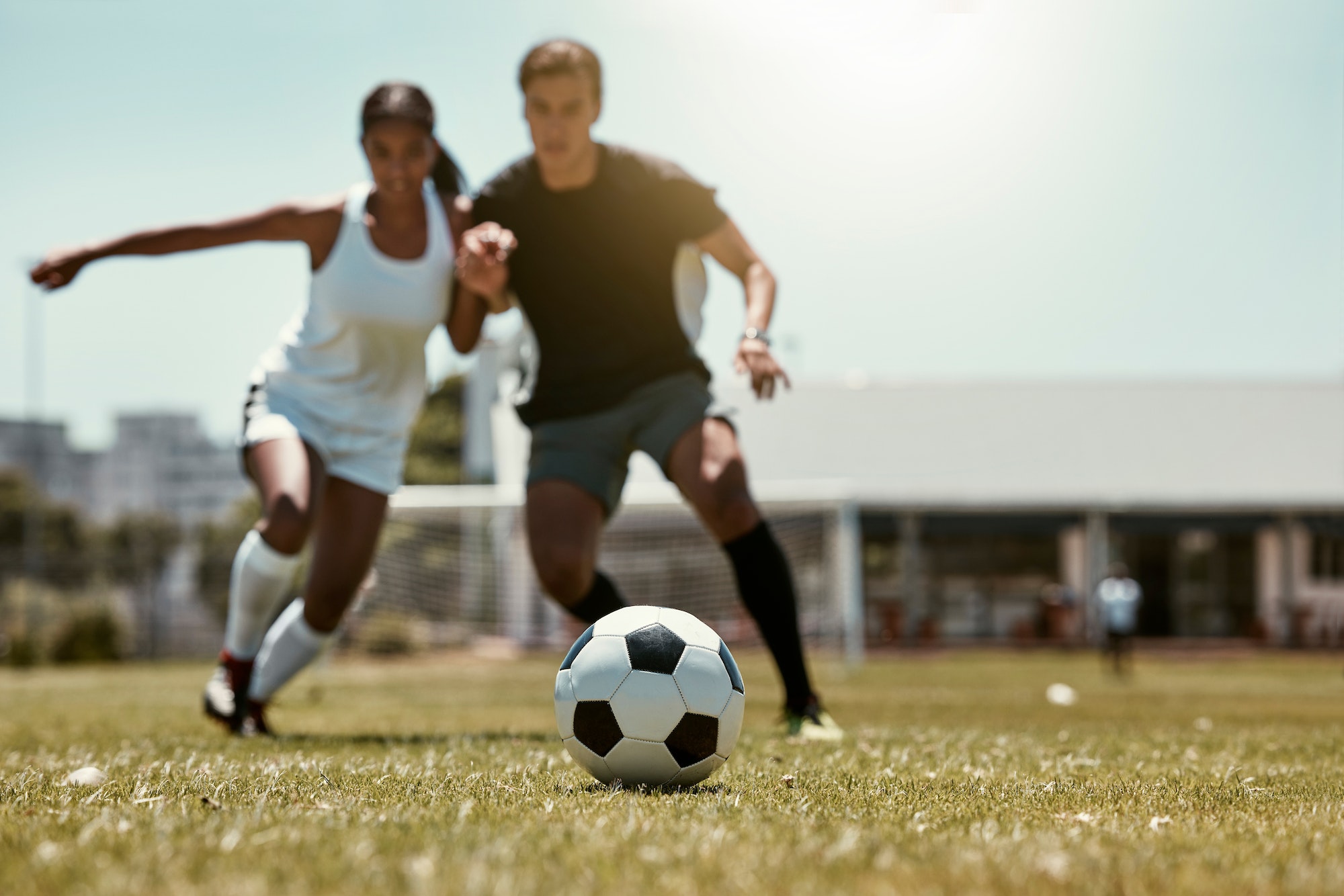 Friends, soccer player and soccer training game on football field for fitness workout on grass outd